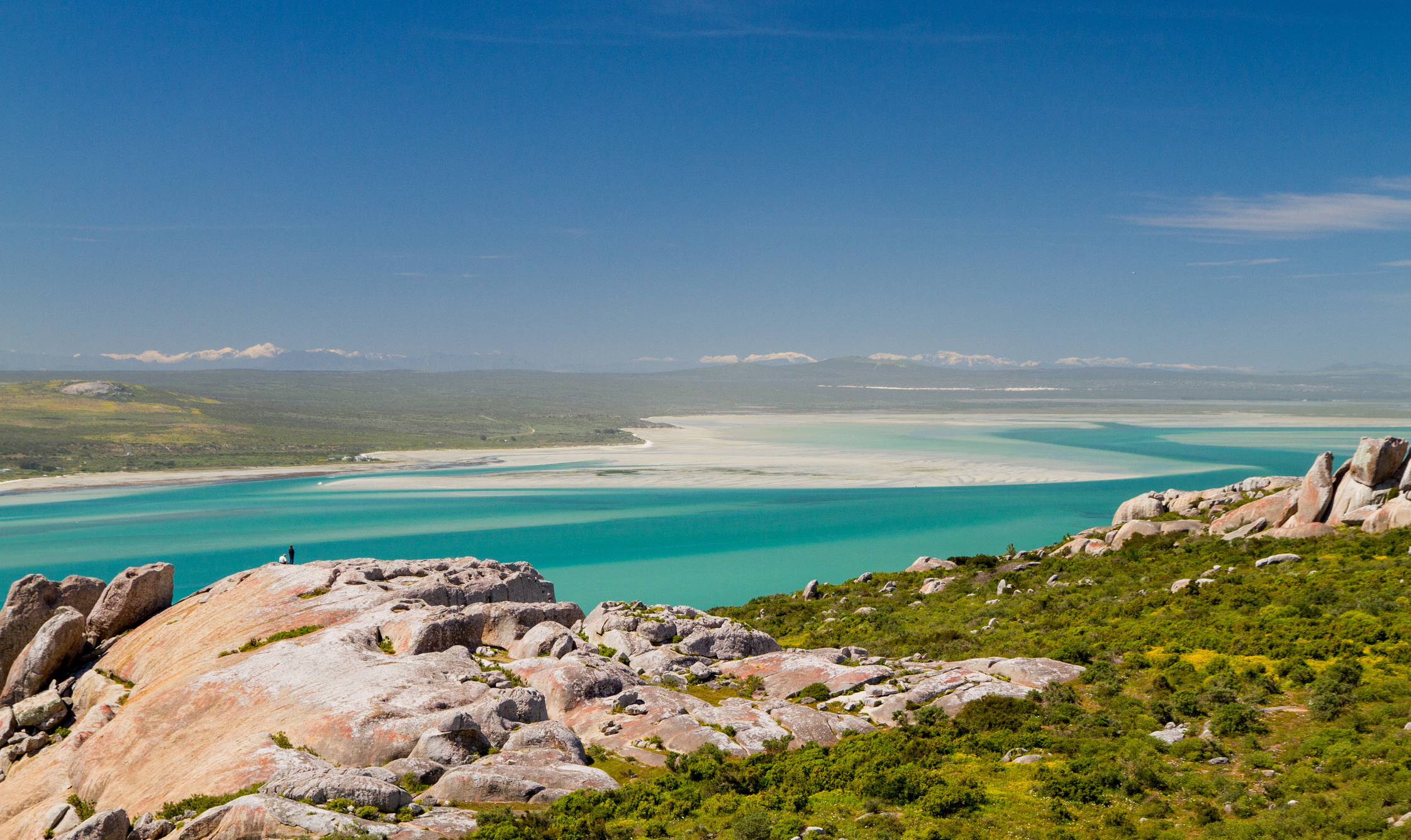 The snow-capped Cederberg mountains and turquoise waters of the Langebaan Lagoon. West Coast National Park, South Africa